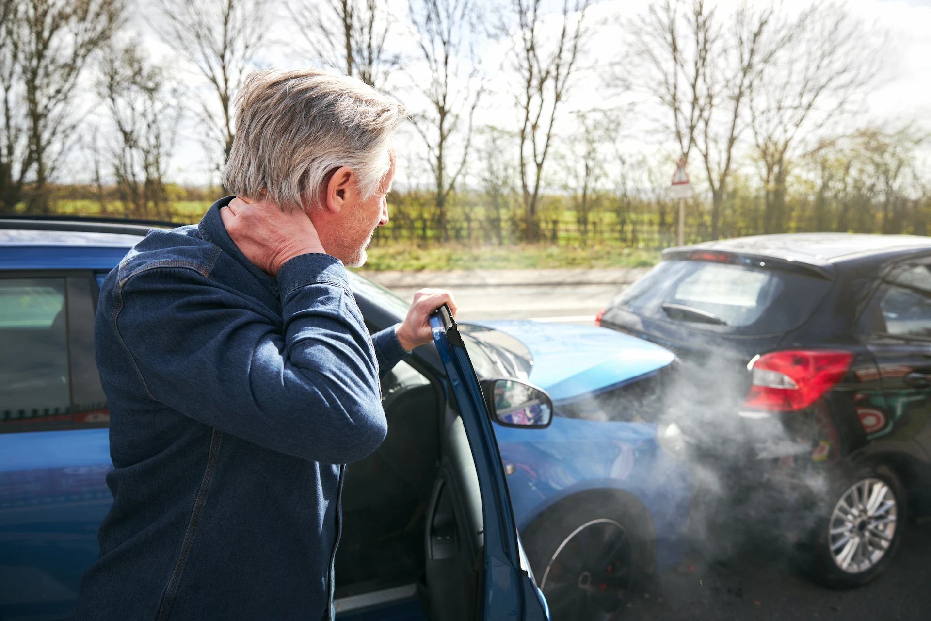 Man experiencing neck pain after car accident, a common whiplash symptom treated with car accident chiropractic care in Nevada.
